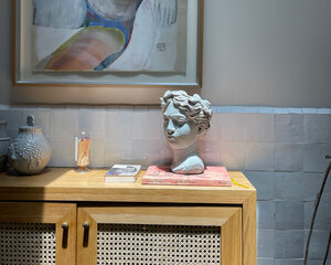 Head sculpture on table