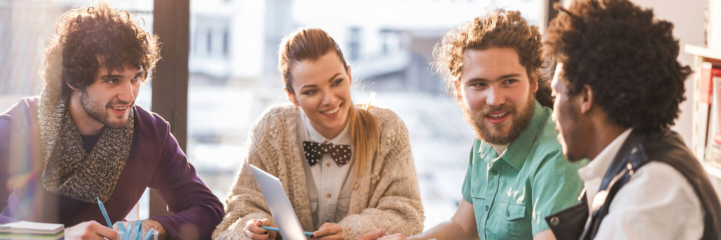 Four producers at a pitch meeting.