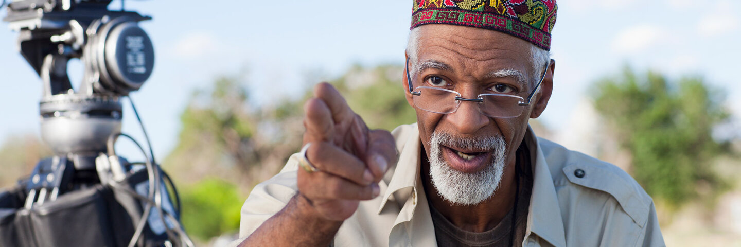 Director pointing at actors off camera.