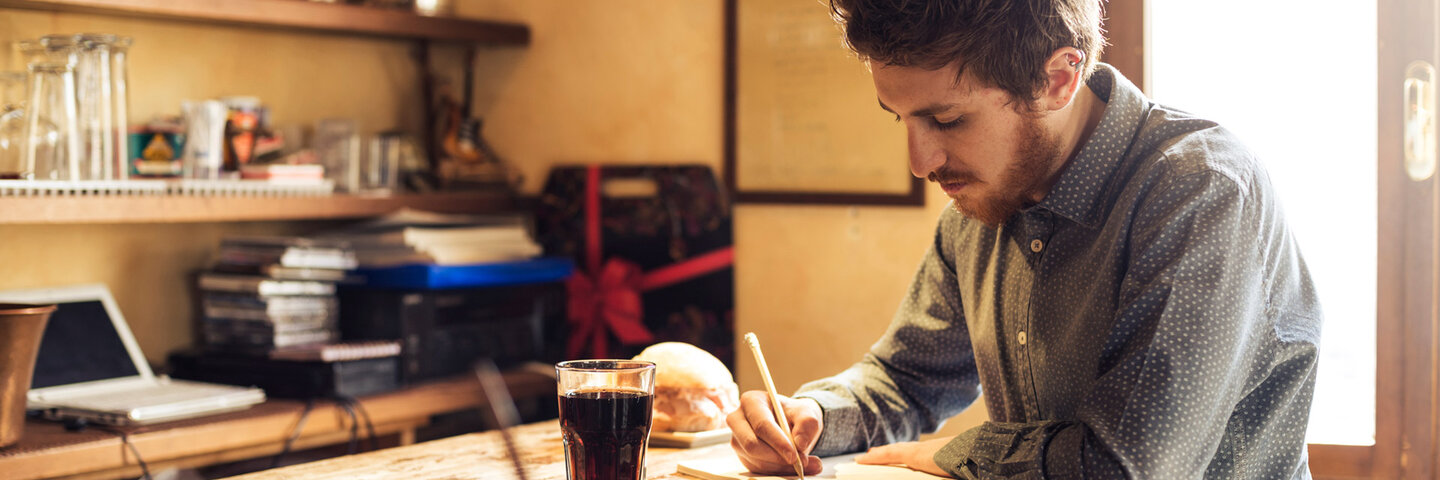 Man writing in a book