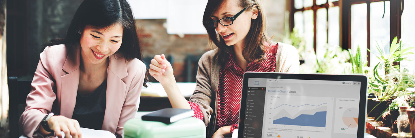 two professionals working at a desk