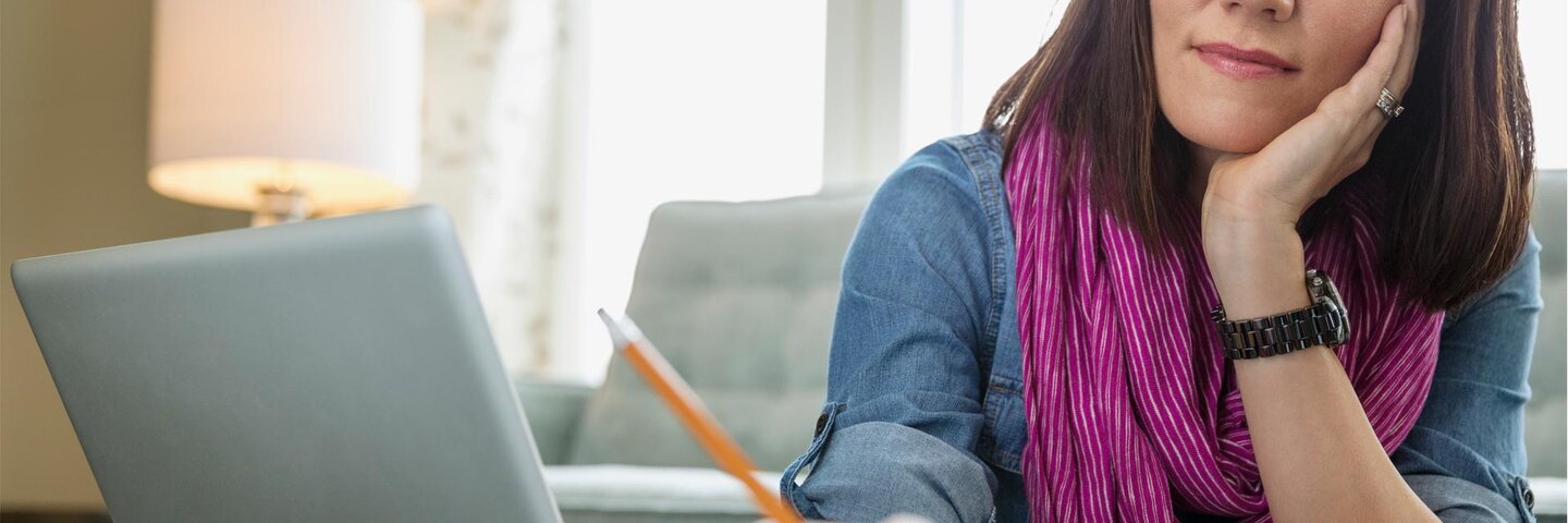 Woman with purple scarf working on screenplay