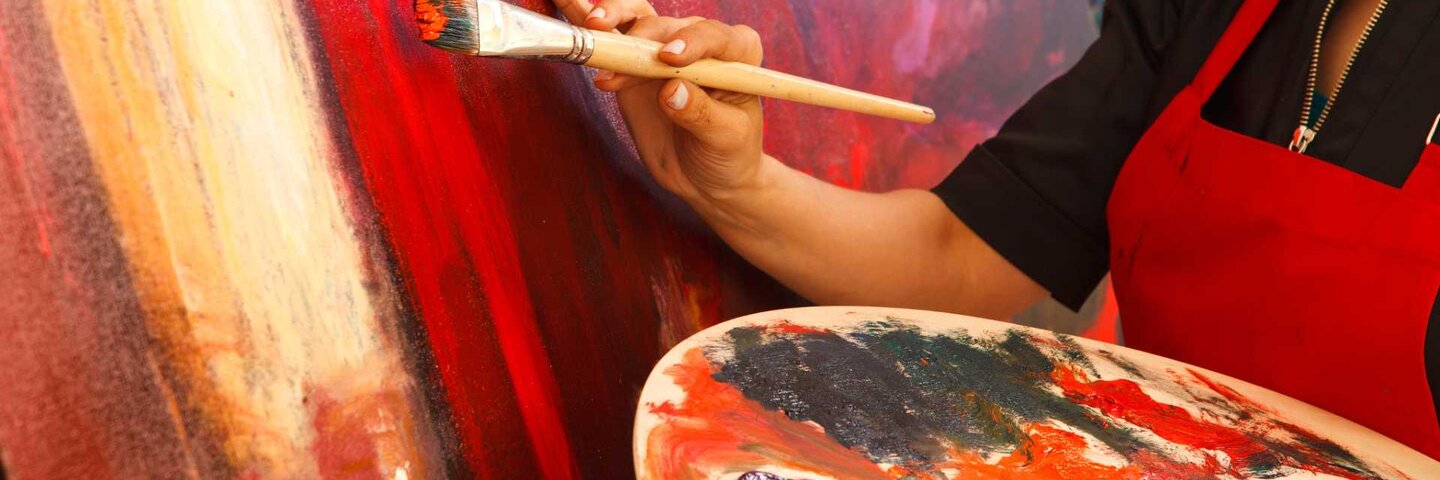 Woman painting on a canvas