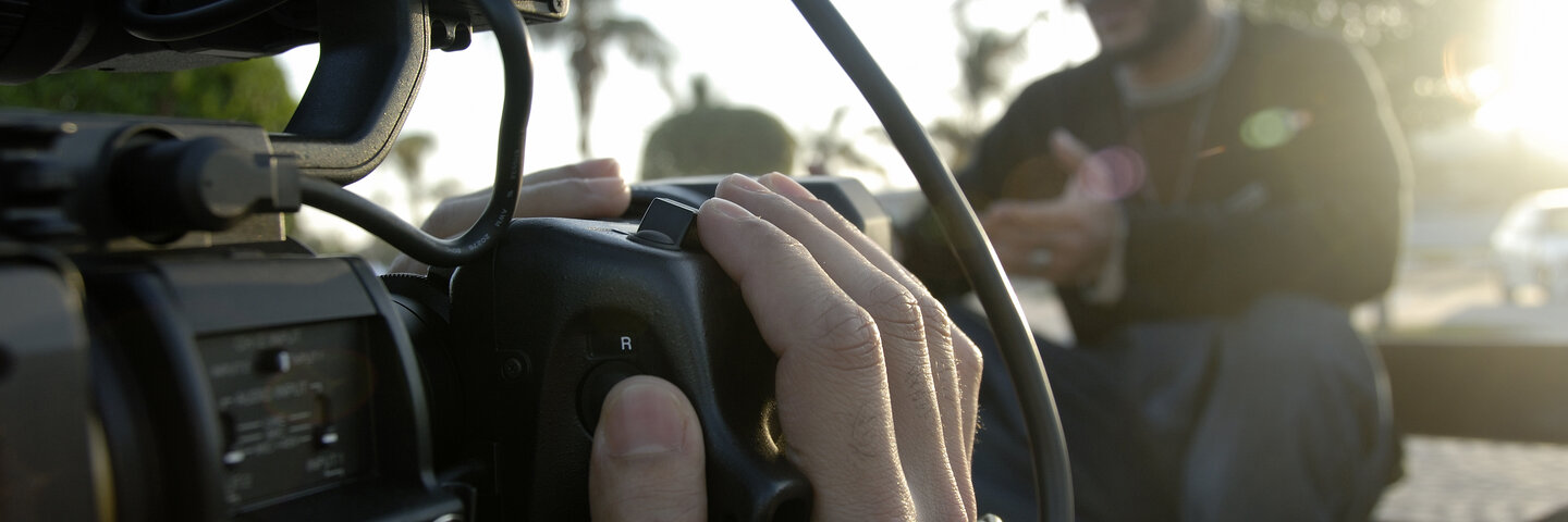 Cameraman Filming a man speaking In daylight