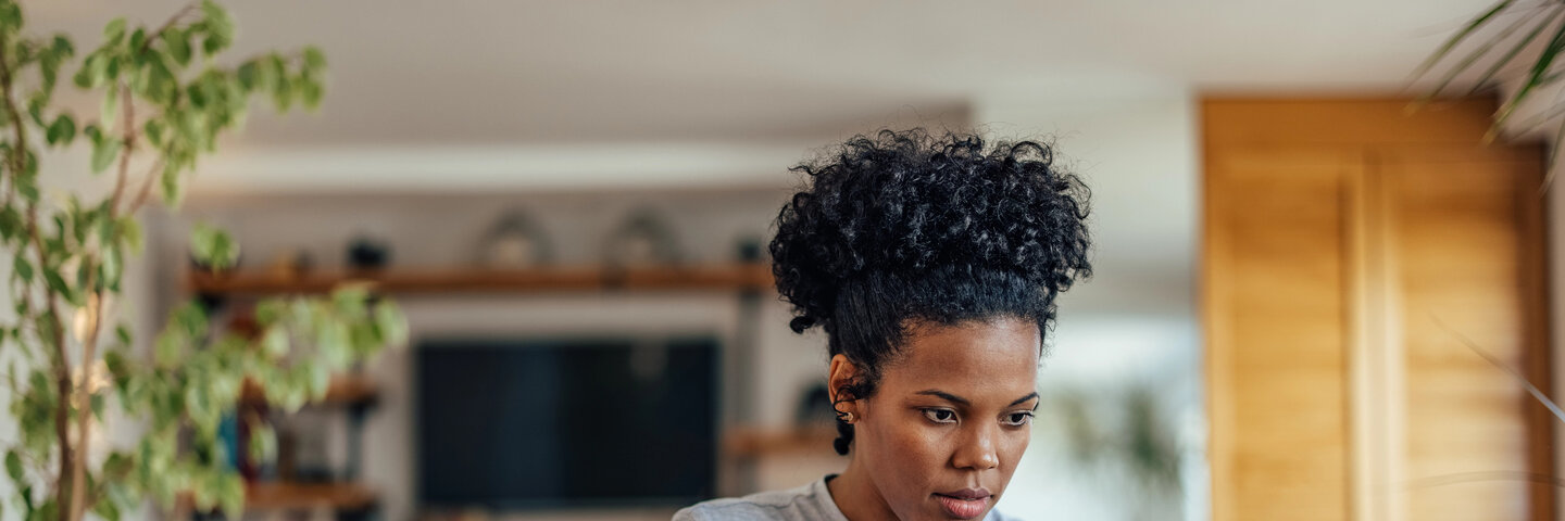 Man with glasses writing article on laptop