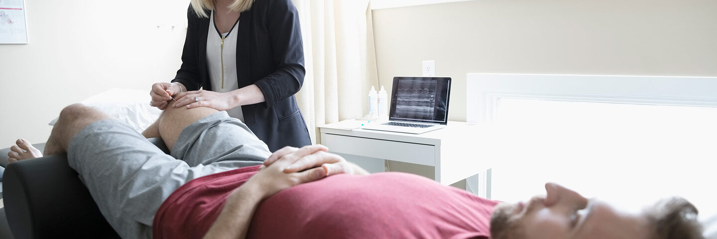 sports doctor analyzing her patient