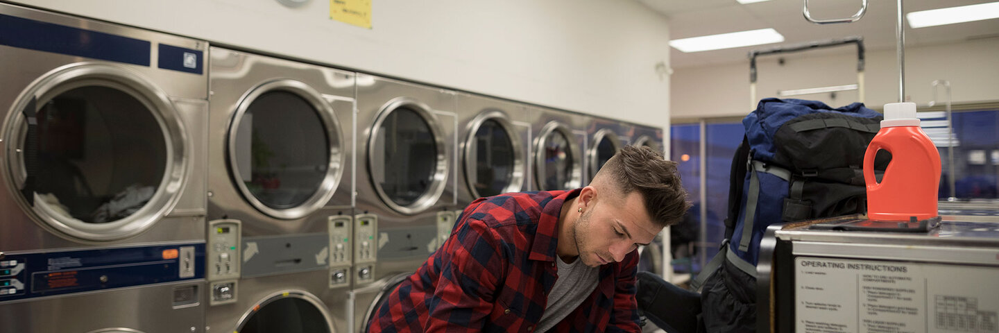 Man writing at the laudromat