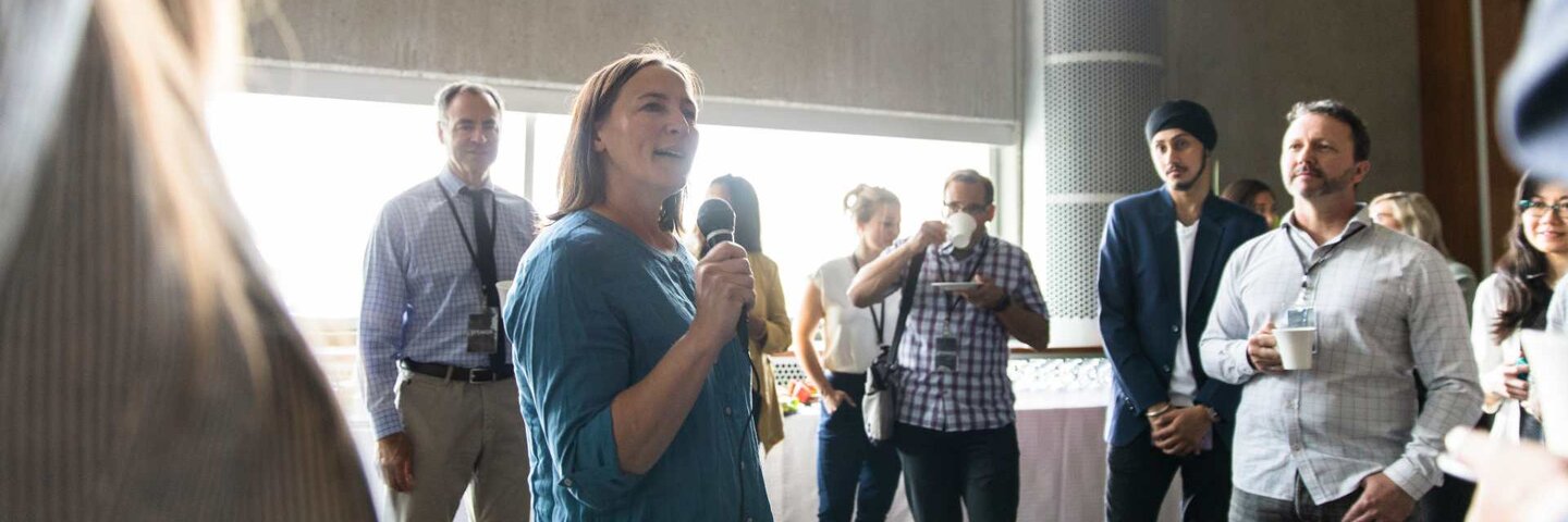 Woman speaking in front of gathering
