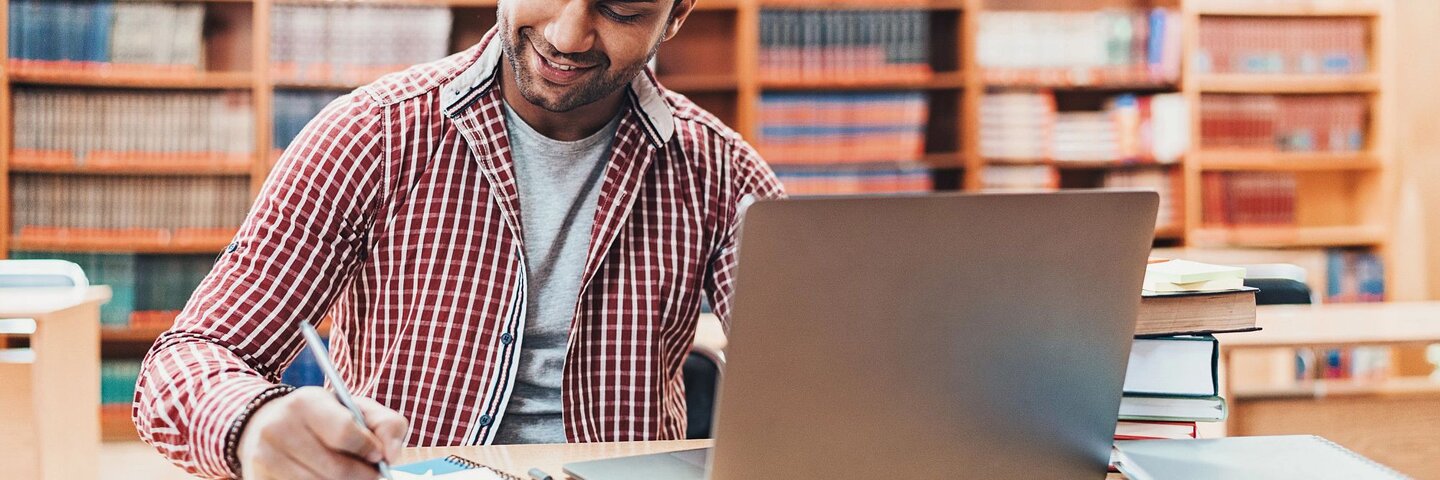 indian man studying with his laptop