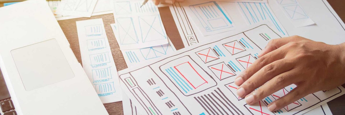 Person drawing out wireframes for a website