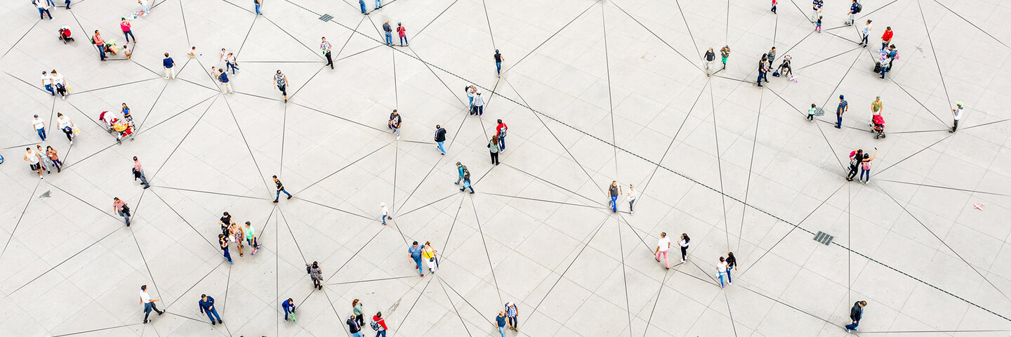 people dispersed across a matrix designed plaza