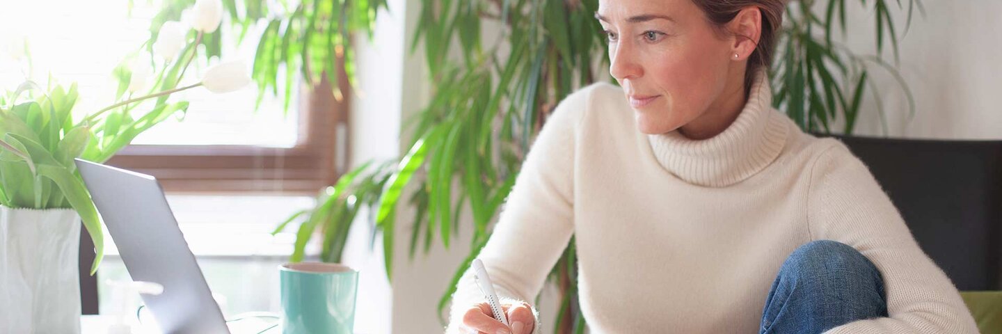 Woman working from home using laptop computer
