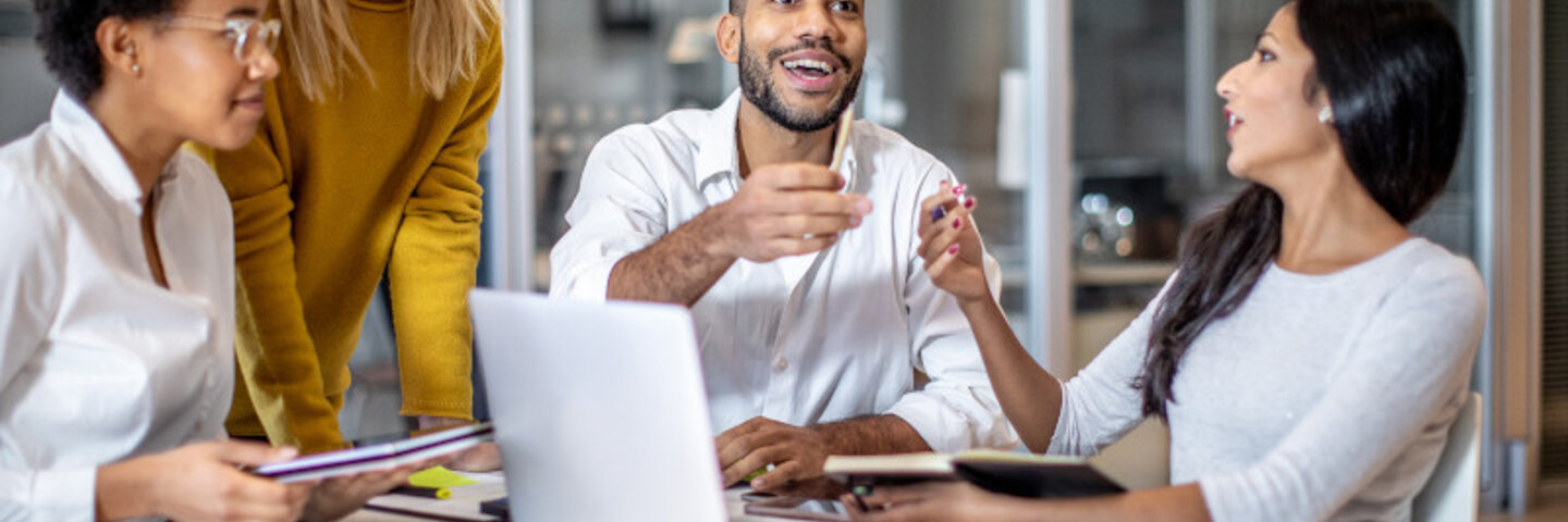 four young business professionals collaborating