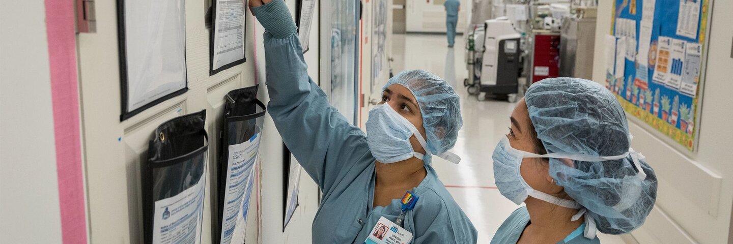 Healthcare workers in masks reviewing files