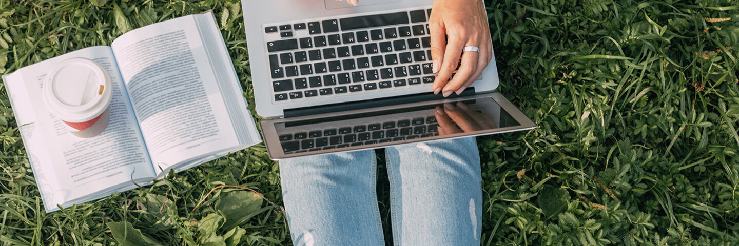 woman with laptop and book