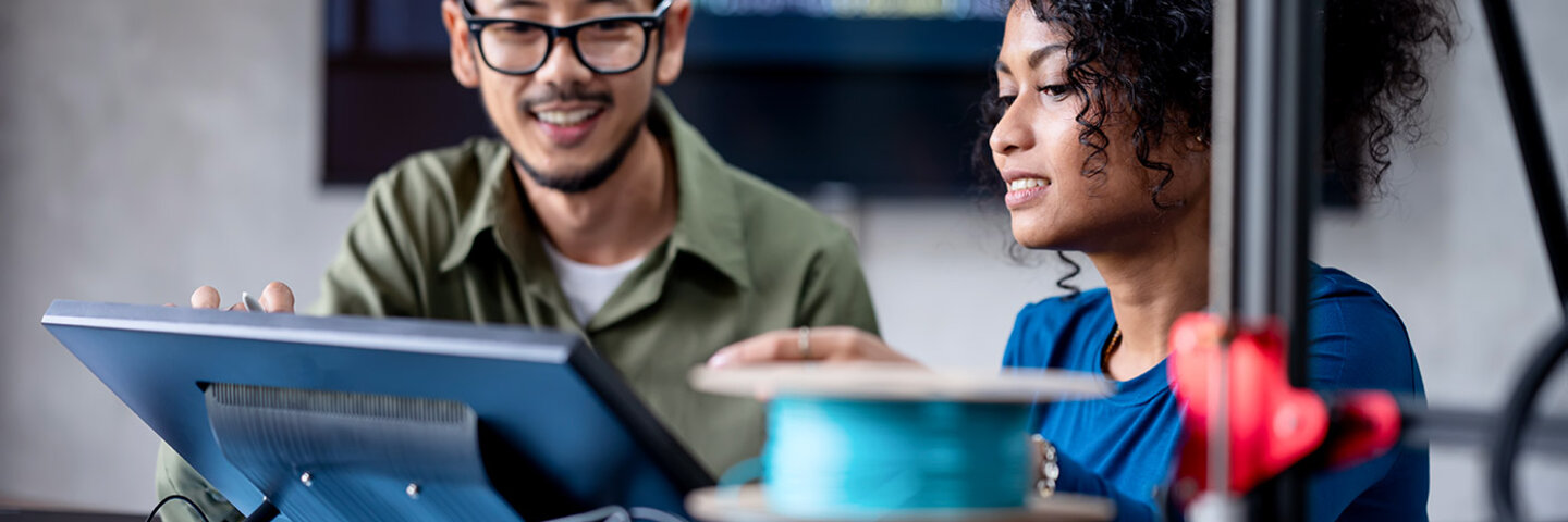man and woman looking at a screen