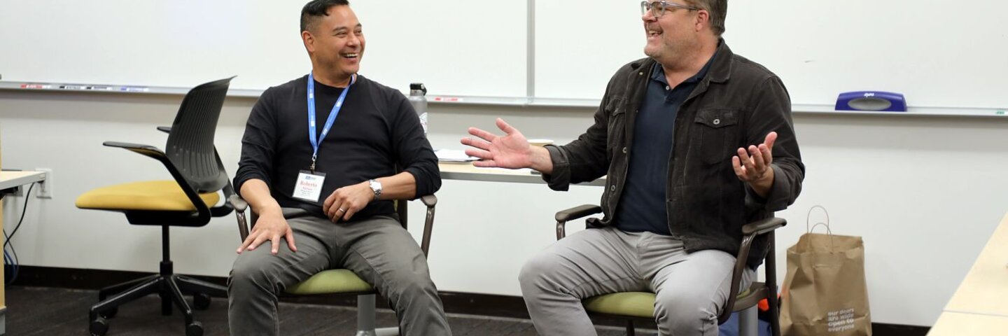 Mentor instructors sitting in a classroom talking