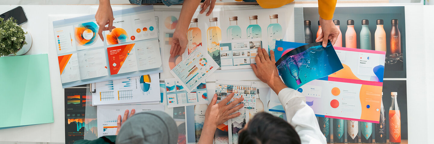 Design Communication Arts - People reviewing designs over desk