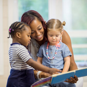 teacher reading with young students