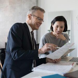 man and woman looking over files