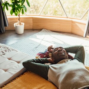 man meditating on the floor of his living room